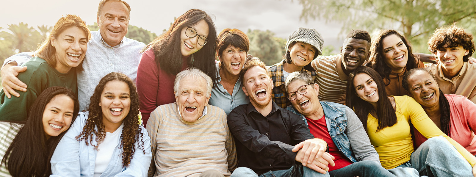 a large group of people of all ages and ethnicities smiling together