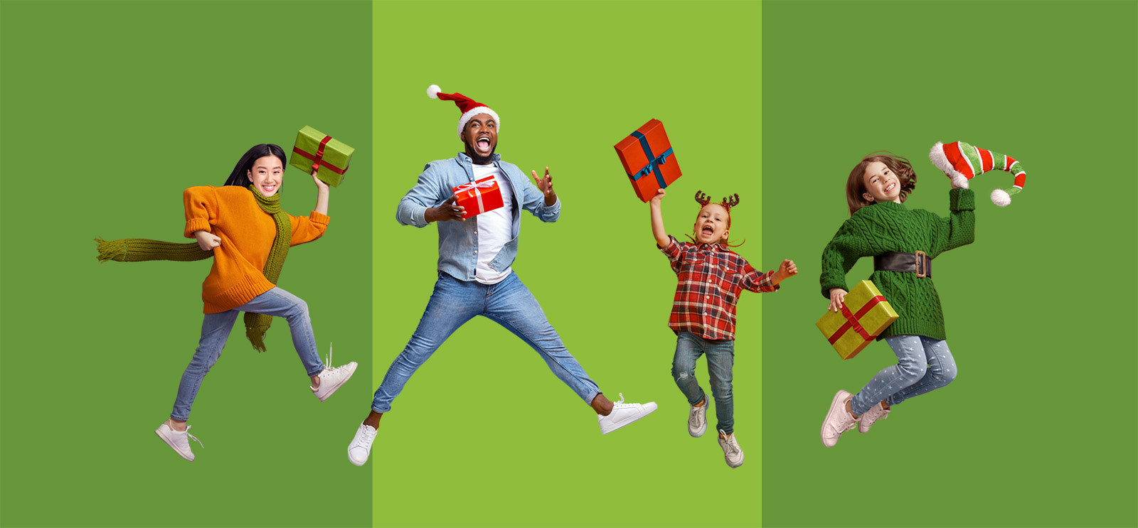 four happy people of various ages jump in the air holding wrapped Christmas gifts